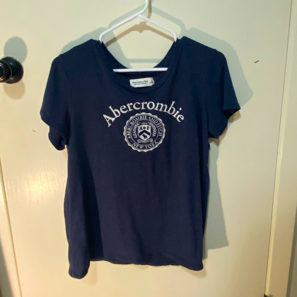 An abercrombie t-shirt with the emblem on the front.
